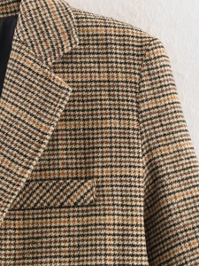 Detailaufnahme des Blazers mit Hahnentrittmuster, Revers und Tweed-Texturqualität