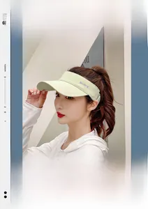 Detail of light green sun visor hat with purple SPORTS embroidery on the wide brim