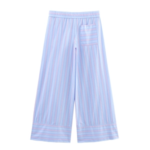 Detail of striped wide-leg trousers featuring elastic waist and red accent stripes