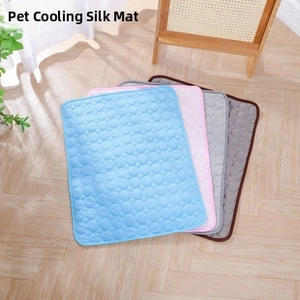 Detail of pet cooling mats in blue, pink, grey, and coffee colors with quilted texture