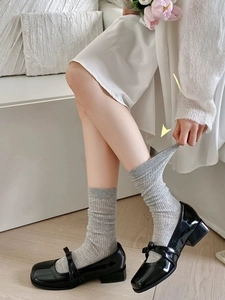 Detail of light grey ribbed knit crew socks with high elasticity and seamless cuff