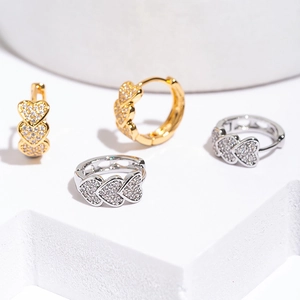 Elegant gold and silver heart-shaped hoop earrings with micro-pave cubic zirconia accents