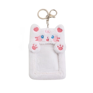 Détail macro du porte-carte chat en peluche blanche avec broderies et fermoir