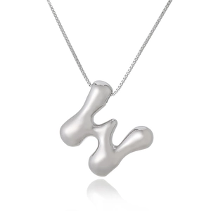 Macro shot of polished silver H-letter pendant with high-shine metallic finish and reflection