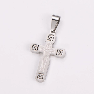 Macro view of silver stainless steel cross pendant with embossed Jesus and Spanish prayer