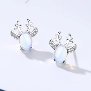 Detailed view of silver reindeer stud earrings featuring opal stones and zirconia