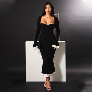 Detail view of black bodycon dress featuring elegant ruffles on sleeves and white lining hem