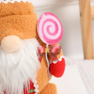 Christmas gnome doll with ginger orange hat holding a candy lollipop for table decor