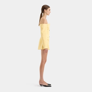 Side view of a yellow off-shoulder blazer dress with button and pocket details