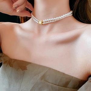 Close-up of 18k gold plated double-layer pearl necklace on female model neck