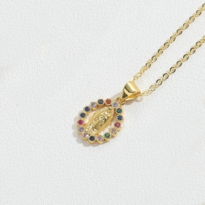 Macro detail of golden Guadalupe pendant with vibrant multi-color zircon stones
