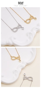 Detail of infinity necklaces with heart pendants in gold and silver finish