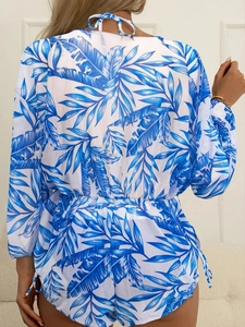 Detail view of tropical leaf print romper with long sleeves and back tie closure