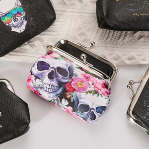 Skull and floral pattern coin purse with metal clasp closure on white fabric