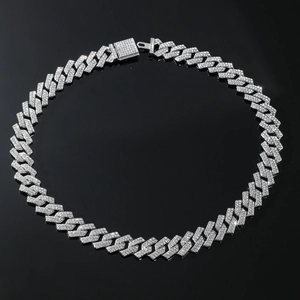 Detail shot of silver Cuban link necklace with sparkling stones and encrusted box clasp