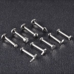 Detailed assortment of G23 titanium labret studs in heart, star, and geometric shapes