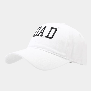 Close-up of white washed cotton baseball cap featuring black embroidered DAD lettering