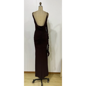 Detail of dark brown backless dress with ruched fishtail hem and draped silhouette