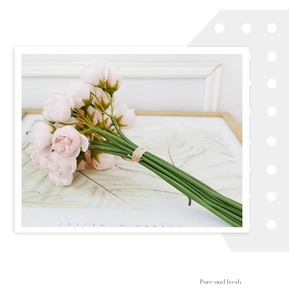 Detailed view of pink artificial tea roses tied with hemp rope for wedding decor