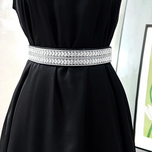 Sparkling rhinestone elastic waist belt with geometric arrow pattern on black dress
