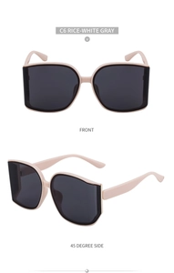 Close-up of oversized square sunglasses in cream white frame with gray lenses