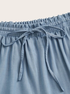 Women's light blue drawstring shorts with elastic waistband and soft fabric texture