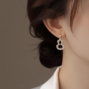 Elegant hollow gourd earrings with pink and white zircon in pale gold plating