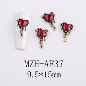 Macro shot of 9.5x15mm red heart gem nail charm with melting gold alloy metal base