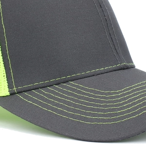 Dark grey trucker cap with neon yellow stitching and breathable mesh side panels
