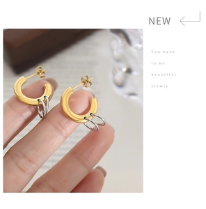 Close-up of dual-tone interlocking metal earrings in gold and silver finish