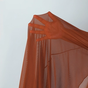 Macro shot of caramel brown ultra-thin mesh fabric showing fine texture and elasticity