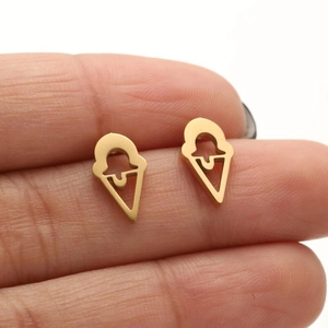Detail shot of golden ice cream cone stud earrings featuring a hollowed-out metal design
