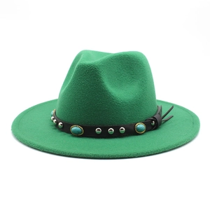 Detail of green felt fedora hat featuring black leather band with turquoise and silver studs