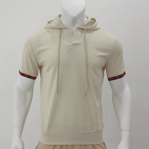 Detail of beige waffle knit short sleeve hoodie featuring red and black plaid sleeve cuffs