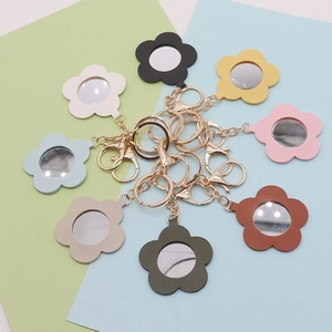 Detailed top view of flower-shaped PU leather mirrors with gold clips in multiple colors