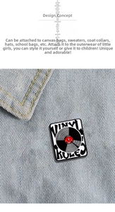 Detail of creative vintage vinyl record enamel pin badge pinned on denim fabric