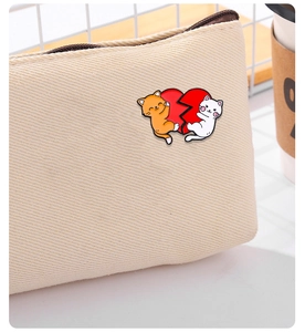 Detail view of cat puzzle enamel pins on a canvas bag for Valentine's Day decor