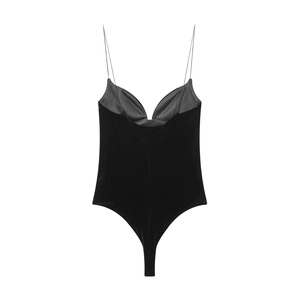 Detailed view of black velvet bodysuit with thin straps and deep V-back cut