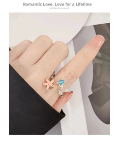 Detail view of turtle and starfish adjustable open ring with sparkling crystal accents