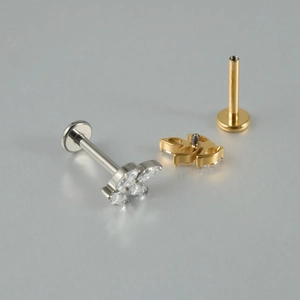 G23 titanium labret studs with zircon flower and leaf designs in silver and gold finish