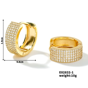 Macro shot of wide gold hoop earrings with multi-row micro-pave white cubic zirconia