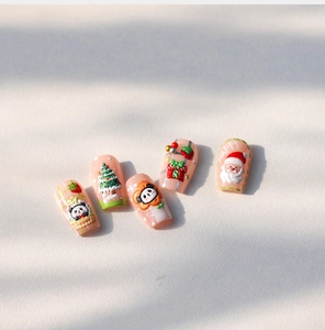 Detail of Christmas-themed 3D embossed nail stickers with Santa and tree motifs