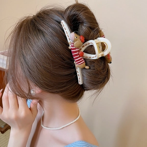 Detail of dachshund shark clip on hair showing strong grip and acrylic star finish