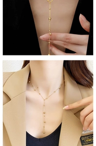 Detail of 18K gold-plated stainless steel Y-necklace with long bead chain tassel charm