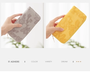 Detail of floral embossed texture on long zip-around wallet with metallic hardware