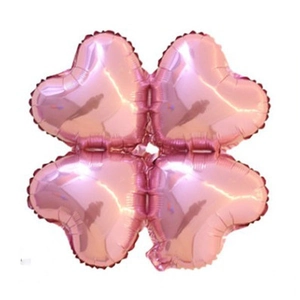Pink foil four-leaf clover balloon with heart shapes for festive party decorations