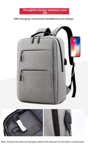 Detail of grey laptop backpack with integrated USB charging port and interior cable pocket