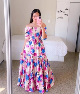 Detail of off-shoulder floral maxi dress featuring puff sleeves and elastic shirred bodice