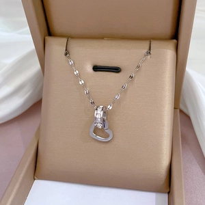 Close-up of double-loop heart pendant necklace with zircon inlay and silver steel chain