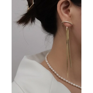 Elegant gold long tassel drop earrings with sleek snake chains on female model